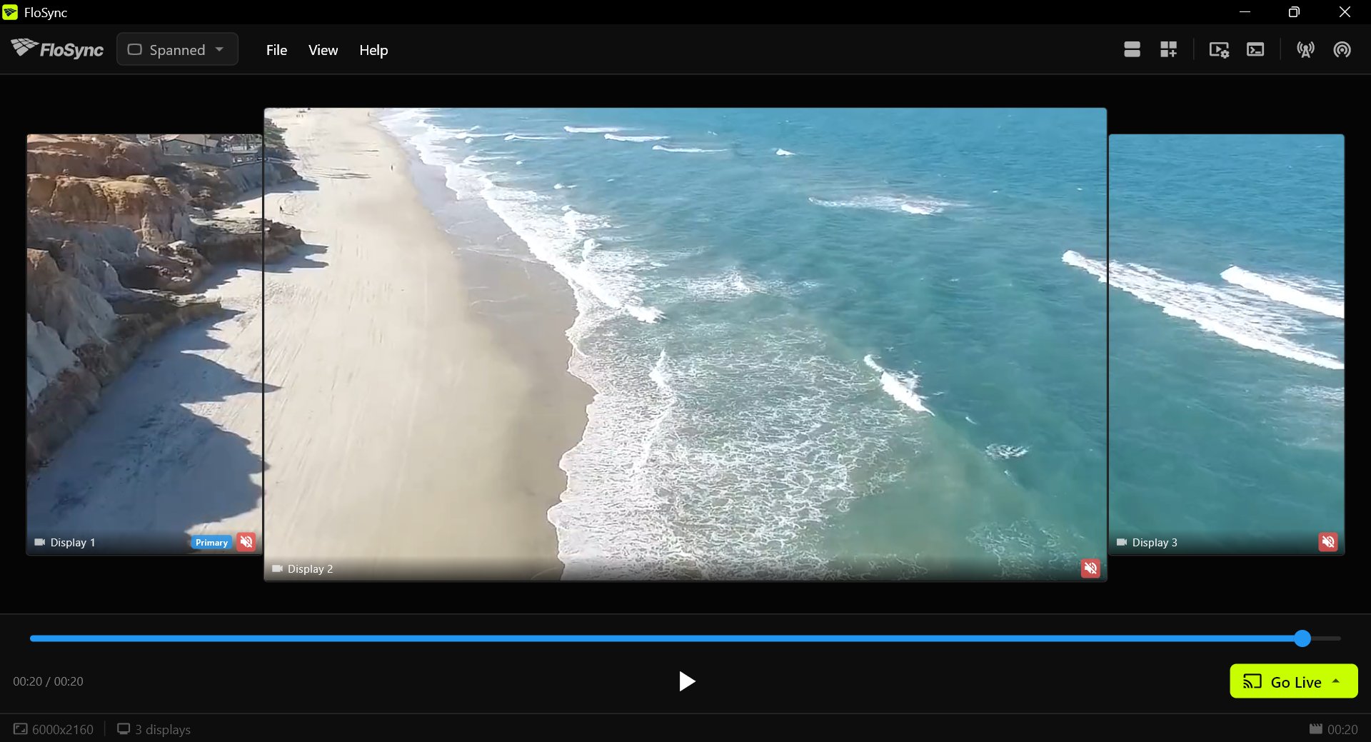 The control panel in Spanned mode with three screen boxes, a tall portrait box on each side of a wide landscape box, showing one continuous beach video.