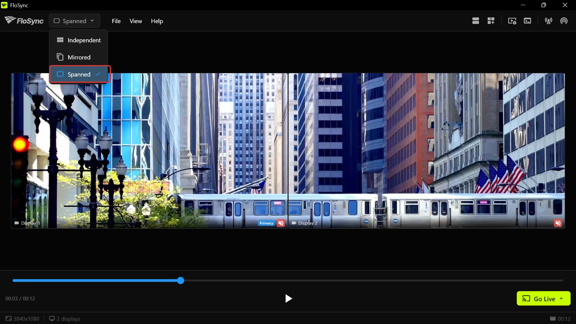 The composer in Spanned mode, with the mode dropdown open showing Independent, Mirrored and Spanned, Spanned checked, the train crossing from one screen to the other