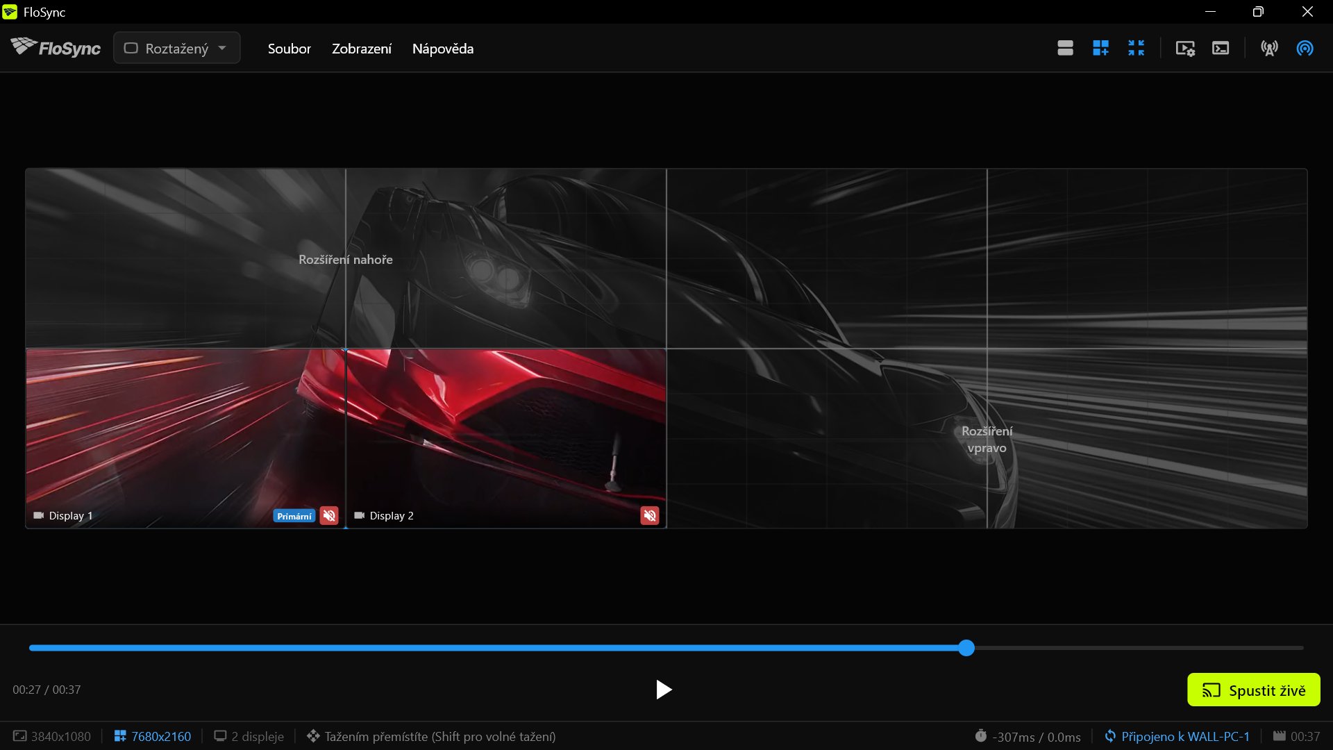 FloSync na PC 3, připojeném k WALL-PC-1, během přetahování v zobrazení celé stěny: jeho dvě místní obrazovky barevně v levé dolní čtvrtině, zbytek stěny šedý a označený „Rozšíření nahoře“ a „Rozšíření vpravo“.