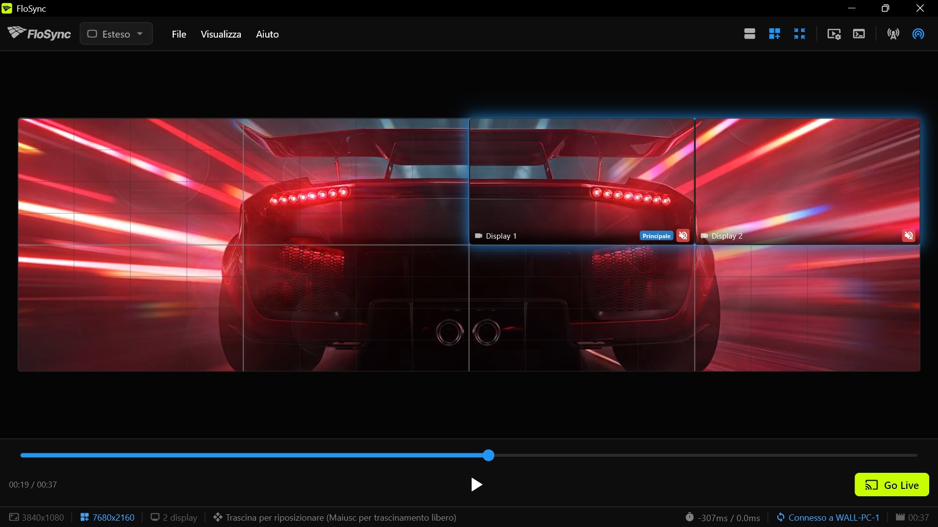 La vista dell'intero muro di FloSync sul PC 2 a 00:19, con l'auto sportiva vista da dietro lungo il muro e la coppia del PC 2 evidenziata nel quadrante in alto a destra
